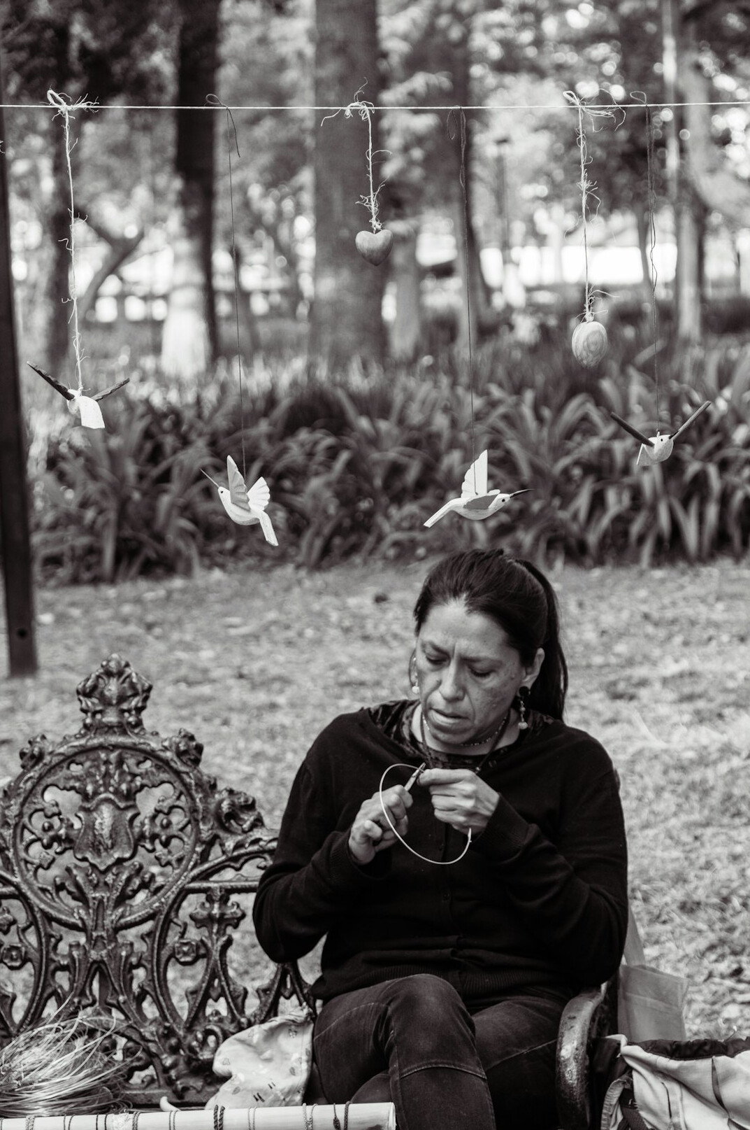 Mexican woman reading a book on a park bench