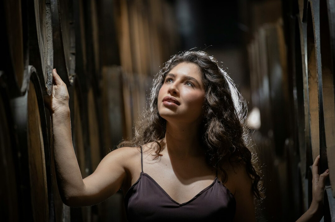 Studio portrait of a young Mexican woman with curly hair