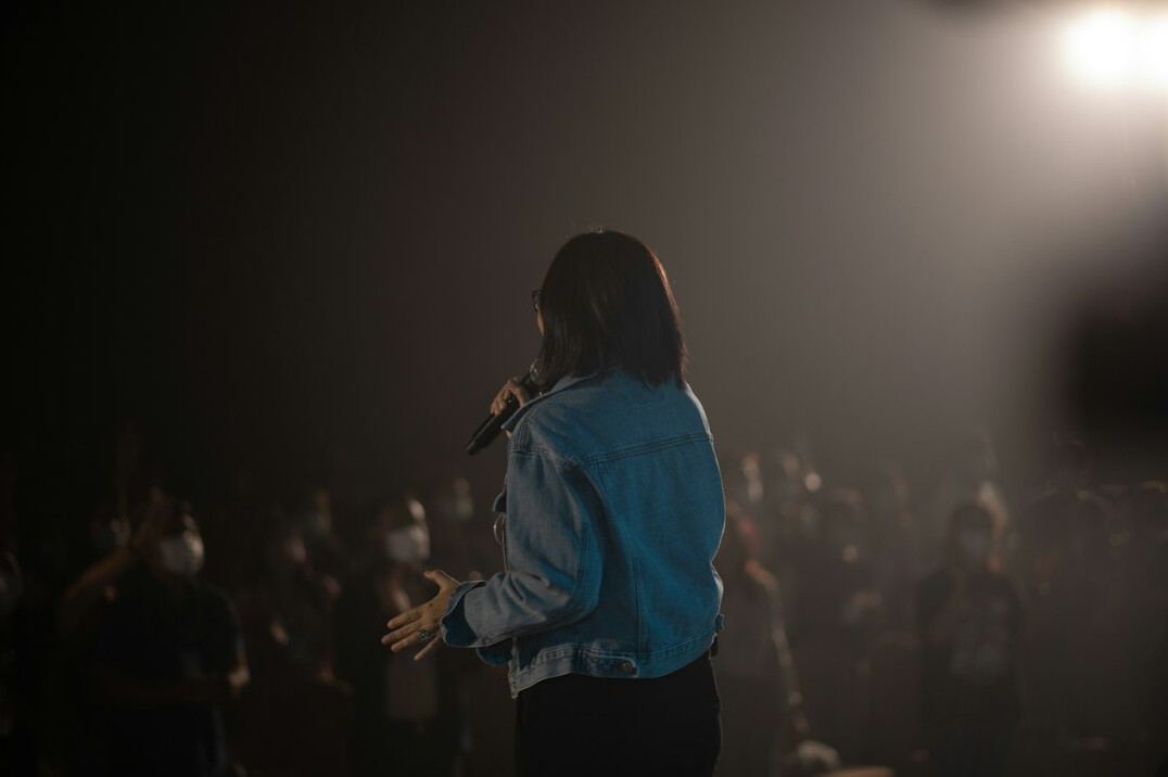confident woman speaking on stage