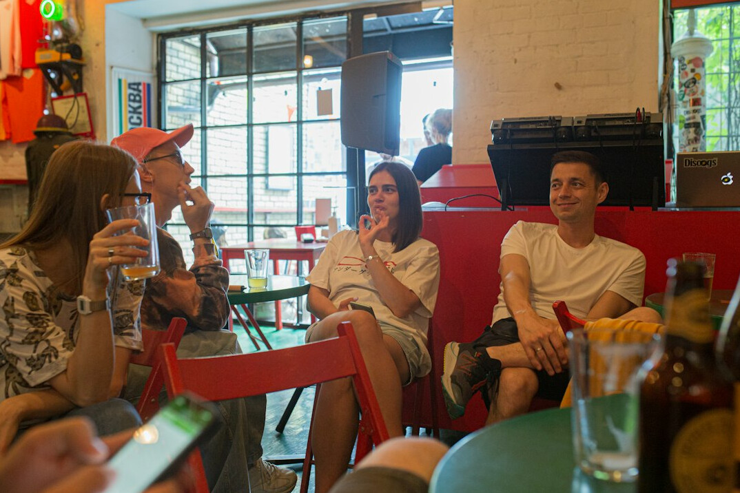 Diverse group of Mexican adults talking in a discussion circle